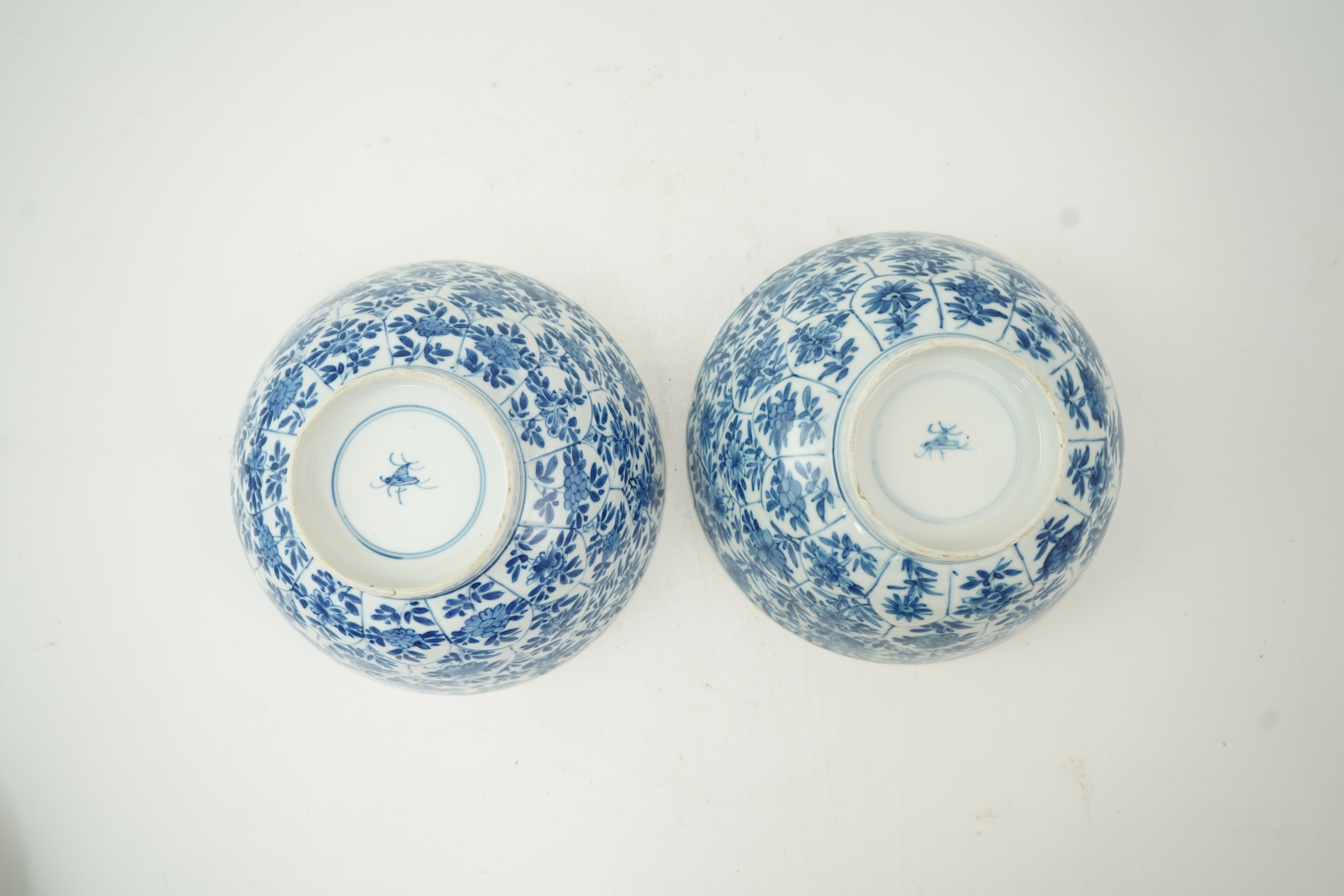 A near pair of Chinese blue and white lotus flower moulded bowls, Kangxi period